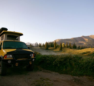Campervan in valley at dusk
